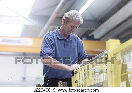 Engineer working in engineering plant View Large Photo Image Stock Photo - Engineer working in engineering plant. Fotosearch