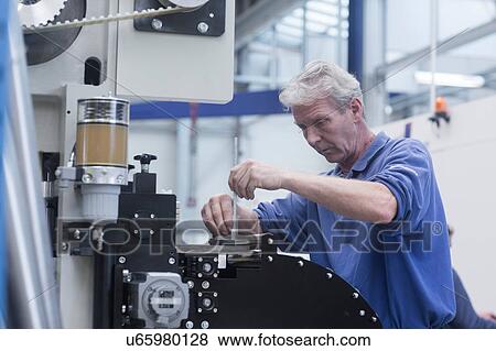 Engineer working in engineering plant View Large Photo Image Stock Photo - Engineer working in engineering plant. Fotosearch