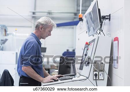 Stock Photo - Engineer working in engineering plant. Fotosearch