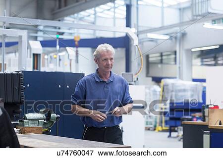 Stock Photo - Engineer working in engineering plant. Fotosearch