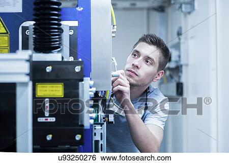 Stock Photograph - Engineer working in engineering plant. Fotosearch