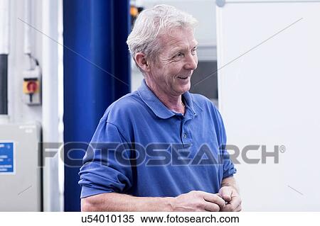 Stock Photography - Engineer working in engineering plant. Fotosearch