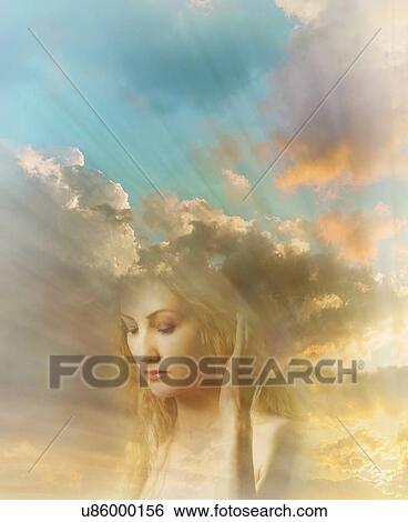 Stock Photograph - Face of young woman with sunrays and cloudy sky in background. Fotosearch