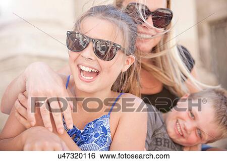 Stock Photograph - Family hugging and tickling. Fotosearch