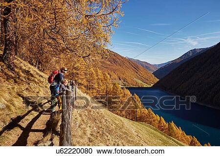 Stock Image - Family looking at view, Schnalstal, South Tyrol, Italy. Fotosearch