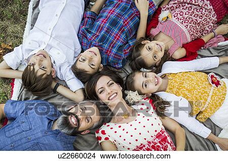Family lying on grass View Large Photo Image Picture - Family lying on grass. Fotosearch