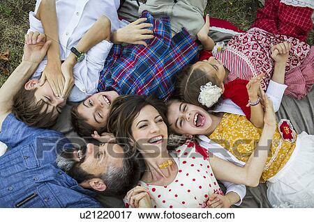 Family lying on grass View Large Photo Image Stock Photo - Family lying on grass. Fotosearch