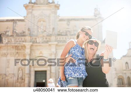 Stock Image - Family posing for selfie, Piazza del Duomo, Lecce, Italy. Fotosearch