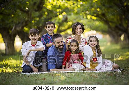Family sitting and smiling View Large Photo Image Stock Photo - Family sitting and smiling. Fotosearch