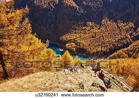 Family sitting on bench, high angle view, Schnalstal, South Tyrol, Italy View Large Photo Image Stock Image - Family sitting on bench, high angle view, Schnalstal, South Tyrol, Italy. Fotosearch