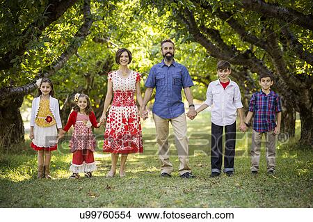 Family standing, holding hands View Large Photo Image Picture - Family standing, holding hands. Fotosearch