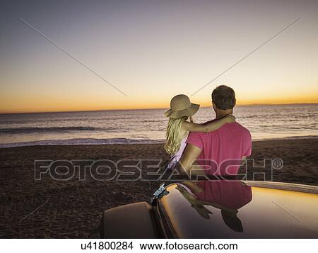 Picture - Father and daughter (4-5) looking at sea. Fotosearch