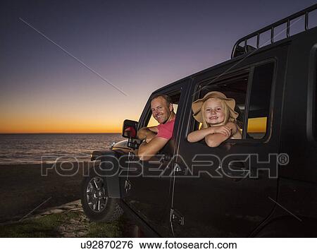Father and daughter (4-5) sitting in car on beach View Large Photo Image Stock Photograph - Father and daughter (4-5) sitting in car on beach. Fotosearch