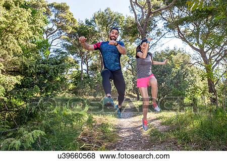 Female and male runners jumping mid air in park, Split, Dalmatia, Croatia View Large Photo Image Stock Photo - Female and male runners jumping mid air in park, Split, Dalmatia, Croatia. Fotosearch