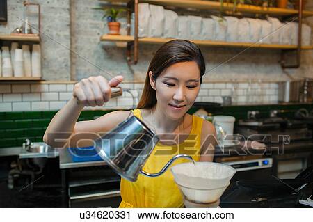 Female barista preparing filter coffee in cafe View Large Photo Image Stock Image - Female barista preparing filter coffee in cafe. Fotosearch