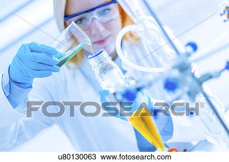 Stock Image - Female chemist working. Fotosearch