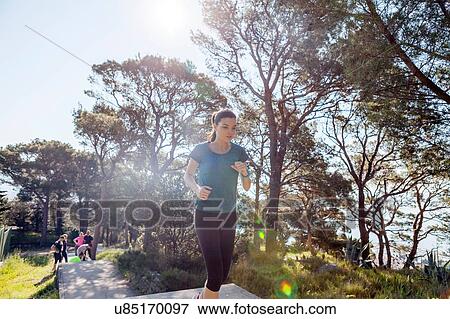 Stock Photo - Female runner running up park stairway, Split, Dalmatia, Croatia. Fotosearch