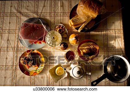 Stock Photograph - Food, teapot and saucepan on table, overhead view. Fotosearch