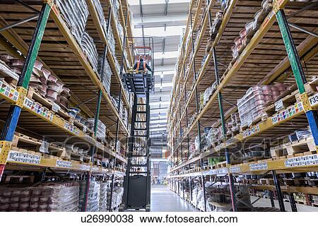 Stock Photo - Forklift driver in cable store warehouse at cable storage facility. Fotosearch