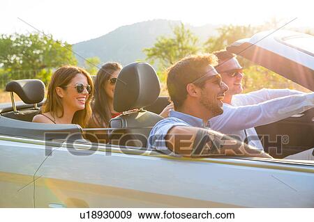 Four adult friends driving on rural road in convertible, Majorca, Spain View Large Photo Image Stock Photo - Four adult friends driving on rural road in convertible, Majorca, Spain. Fotosearch