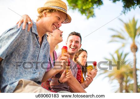 Four adult friends laughing and eating ice cream cones, Majorca, Spain View Large Photo Image Stock Image - Four adult friends laughing and eating ice cream cones, Majorca, Spain. Fotosearch