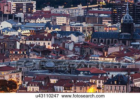Stock Photo - France, Auvergne-Rhone-Alpes, Clermont-Ferrand, Cityscape at dusk. Fotosearch