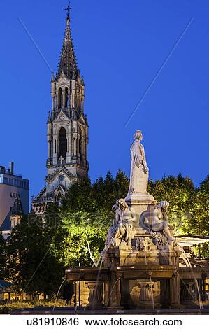 Stock Photograph - France, Occitanie, Nimes, Esplanade Charles De Gaulle with fountain at dusk. Fotosearch