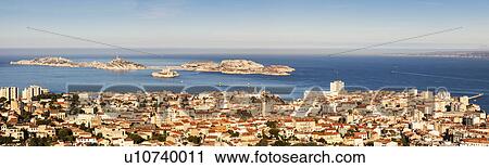 Stock Image - France, Provence-Alpes-Cote d'Azur, Marseille, Cityscape with sea in background. Fotosearch