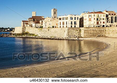 Stock Image - France, Provence-Alpes-Cote d'Azur, Antibes, Empty beach with buildings in background. Fotosearch