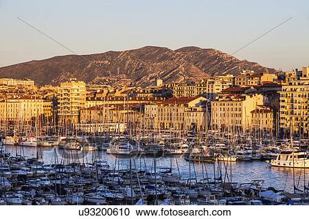 Stock Image - France, Provence-Alpes-Cote d'Azur, Marseille, Vieux port - Old Port with mountain in background. Fotosearch