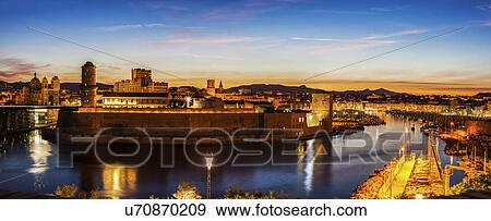 Stock Photo - France, Provence-Alpes-Cote d'Azur, Marseille, Fort Saint-Jean and Marseille Cathedral at sunset. Fotosearch