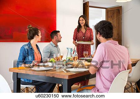 Stock Image - Friends dining together. Fotosearch
