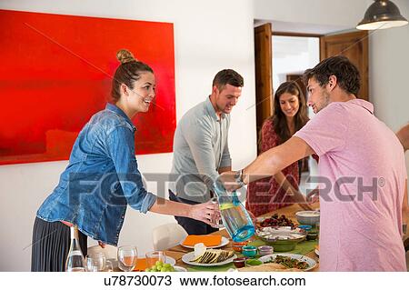 Stock Image - Friends dining together. Fotosearch
