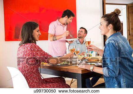 Stock Image - Friends dining together. Fotosearch