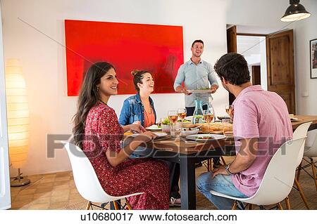 Stock Photo - Friends dining together. Fotosearch