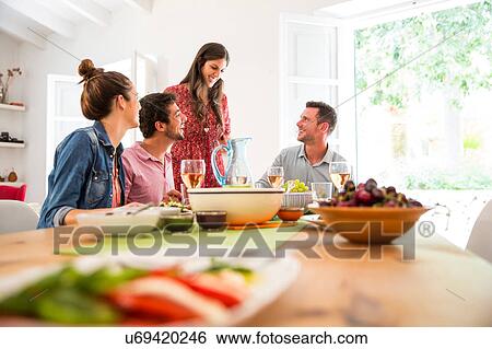 Stock Photograph - Friends dining together. Fotosearch