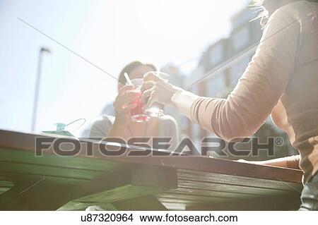 Picture - Friends enjoying drinks in pub, London. Fotosearch