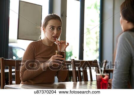 Picture - Friends enjoying drinks in pub, London. Fotosearch