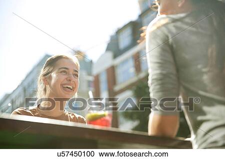 Stock Image - Friends enjoying drinks in pub, London. Fotosearch
