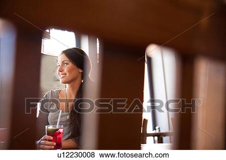 Stock Photo - Friends enjoying drinks in pub, London. Fotosearch