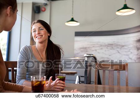 Stock Photo - Friends enjoying drinks in pub, London. Fotosearch