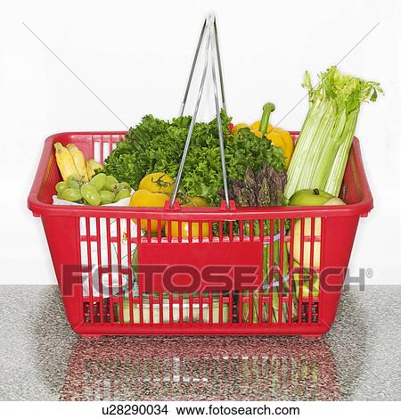 Fruits and vegetables in grocery basket on countertop View Large Photo Image Picture - Fruits and vegetables in grocery basket on countertop. Fotosearch