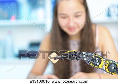 Stock Image - Girl controlling robot. Fotosearch