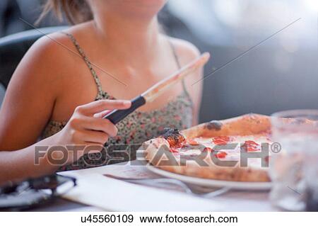 Girl eating sourdough pizza View Large Photo Image Stock Photo - Girl eating sourdough pizza. Fotosearch