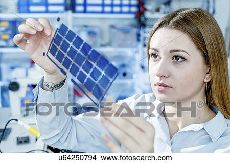 Girl holding film solar cells View Large Photo Image Picture - Girl holding film solar cells. Fotosearch