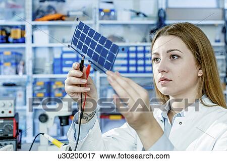 Stock Photo - Girl holding film solar cells. Fotosearch