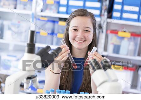 Girl holding test tubes View Large Photo Image Stock Photo - Girl holding test tubes. Fotosearch