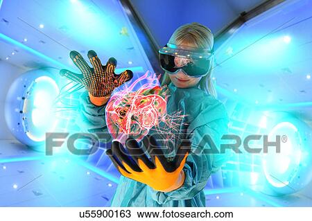 Girl in virtual reality headset interacting with digital floating human heart View Large Photo Image Stock Image - Girl in virtual reality headset interacting with digital floating human heart. Fotosearch