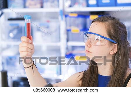 Stock Photo - Girl looking at test tubes. Fotosearch