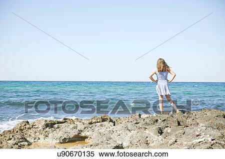 Girl looking out to sea, Puglia, Italy View Large Photo Image Stock Photography - Girl looking out to sea, Puglia, Italy. Fotosearch